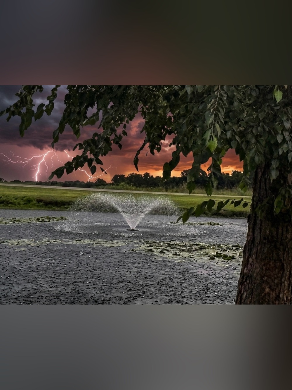 Lightning Over Pond Photographic Art Print in Orange and Green